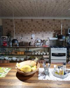 a kitchen with a bowl of fruit on a table at 1054 Holiday Home in Kasane Airport +2 photos