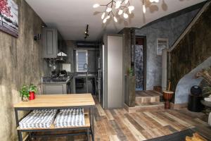 a kitchen with a wooden table in a room at Charming Duplex Mauritius' Little Venice in Terre Rouge