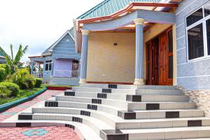 a house with stairs in front of it at JK Maasai Hotel in Wasso +2 photos