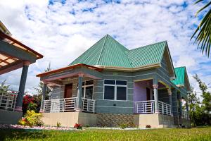 a green roofed house with a green roof at JK Maasai Hotel in Wasso