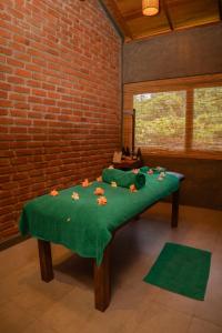 a room with a green table with flowers on it at Fresco Water Villa in Sigiriya