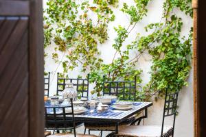 a table with plates and bowls on top at Vasilikos Mansion - Captains Residences in Lindos +38 photos