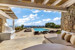a villa with a swimming pool and a patio at Your private Mykonos Villa in Kalafatis