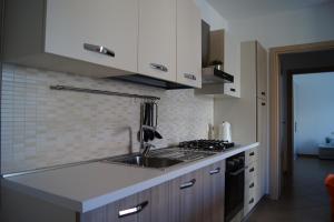 a kitchen with a sink and a stove at Le Dune per 4 in Silvi Marina