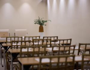a room with tables and chairs and a vase of flowers at Ydor Hotel & Spa by Sandglass in Vourkari +91 photos