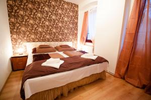 a bedroom with a bed with two towels on it at Hotel City Pisek in Písek