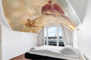 a bedroom with a ceiling with a painting on it at Holstebro Apartments in Holstebro