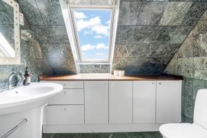 a bathroom with a sink and a window at Holstebro Apartments in Holstebro +37 photos