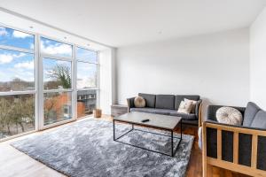 a living room with a couch and a table at Holstebro Apartments in Holstebro