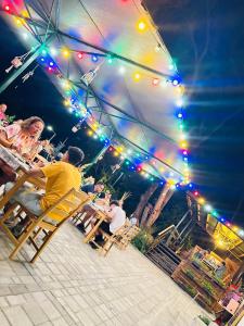 a group of people sitting in chairs under a tent at Sirena Holiday Park in Kamchia