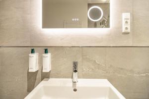 a bathroom with a sink and a mirror at Ferienwohnung Sigi in Traben-Trarbach +17 photos