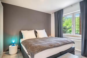 a bedroom with a bed and a large window at Ferienwohnung Sigi in Traben-Trarbach