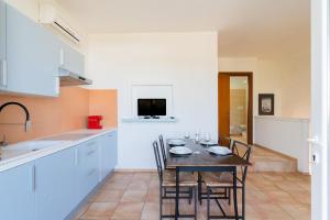 a kitchen with a table and chairs in a room at Residence Quattro Colonne in Santa Maria al Bagno