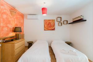 a bedroom with two beds and a painting on the wall at Residence Quattro Colonne in Santa Maria al Bagno +51 photos