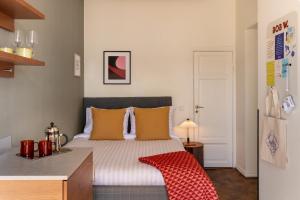 a bedroom with a bed with a red blanket on it at Bob W Stockholm Södermalm in Stockholm