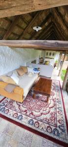 a living room with a couch and a table at Bodónia Vendégház in Bodony