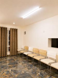 a waiting room with chairs and a flat screen tv at Sunset Villa by Hyatt Stay in Avathi