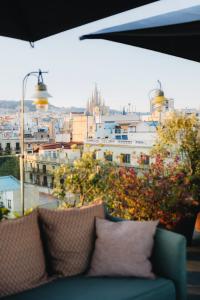 a view of a city from a window with a couch at Uma House by Yurbban Trafalgar in Barcelona