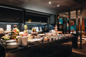 a buffet line with many different types of food at Uma House by Yurbban Trafalgar in Barcelona