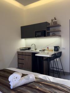a kitchen with a sink and a table with a towel at Railway Studio 2 - Modern Studio in Byblos - Easy city Access in Jbeil