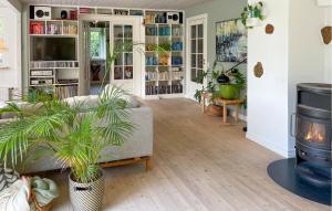 a living room with a couch and potted plants at 3 Bedroom Beautiful Home In Bryrup in Bryrup