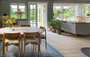 a living room with a table and a couch at 3 Bedroom Beautiful Home In Bryrup in Bryrup
