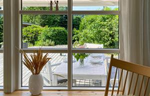 a view of a table and chairs through a window at 3 Bedroom Beautiful Home In Bryrup in Bryrup