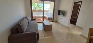 a living room with a couch and a table at Nautical Nest in Livadhia