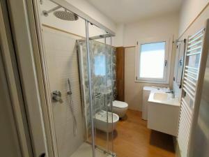 a bathroom with a shower and a toilet and a sink at Sole & Mare in Palmi