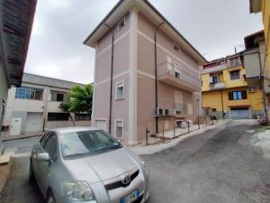 a car parked in a parking lot in front of a building at Sole & Mare in Palmi