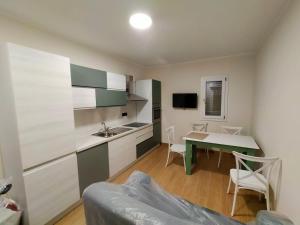 a kitchen and dining room with a table and chairs at Sole & Mare in Palmi