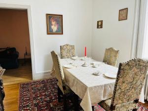 a dining room table with chairs and a red candle on it at Le boudoir de Marie in Montluçon +6 photos