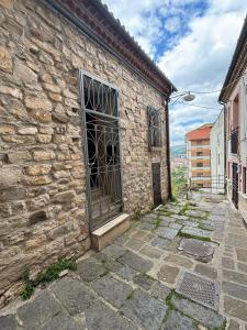 an entrance to a stone building with a gate at Pasitea in Potenza +2 photos