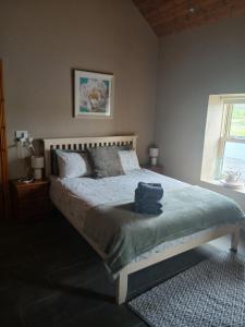 a bedroom with a bed with a bag on it at Liam's Cottage Bed and Breakfast in Lisdoonvarna