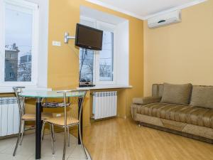 a living room with a table and a couch at Central Studio Tatiana in Kharkiv