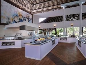 a large kitchen with white counters and a large island at Impressive Punta Cana - All Inclusive in Punta Cana
