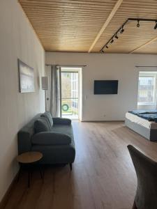 a living room with a couch and a bed at Kaiser von Österreich in Bad Aussee