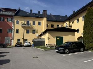 a car parked in a parking lot in front of a building at Kaiser von Österreich in Bad Aussee