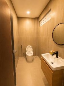 a bathroom with a toilet and a sink at Cloud Nest House Betong in Betong
