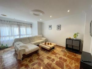 a living room with a couch and a coffee table at Dúplex 2 plantas en Centro histórico de Elche in Elche +40 photos