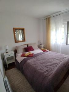 a bedroom with a large bed and a mirror at ODMOR PRESEKA - REST HOUSE PRESEKA in Plužine