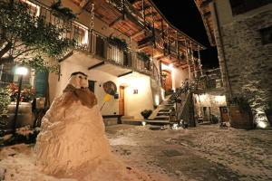 a man in a wedding dress in front of a building at Ostello del Castello Tirano in Tirano
