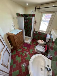 a bathroom with a tub and a toilet and a sink at Happy Journey in Santa Elisabetta