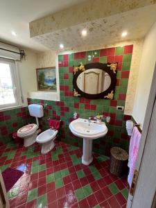 a bathroom with two toilets and a sink and a mirror at Happy Journey in Santa Elisabetta