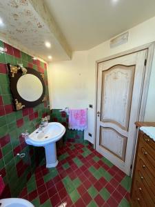 a bathroom with a sink and a mirror and a door at Happy Journey in Santa Elisabetta