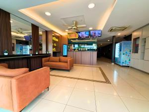 a hospital lobby with two chairs and a bar at Seeds Hotel Cheras Maluri in Kuala Lumpur
