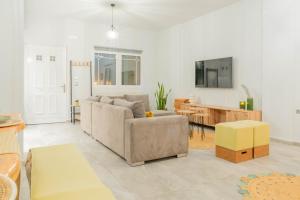 a living room with a couch and a table at Dafni Villa a place to visit by Rentado in Orné