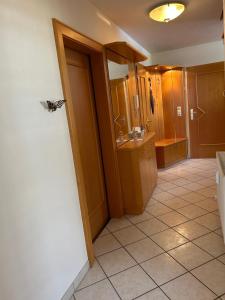 a bathroom with a butterfly sitting on the wall at Bergblick Apartment in Lienz +20 photos