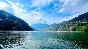 a view of a river with mountains in the background at 22nd Weekend Stays in Bhīm Tāl