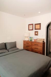 a bedroom with a large bed and a dresser at PHAM. Hotel & Views in Hai Phong